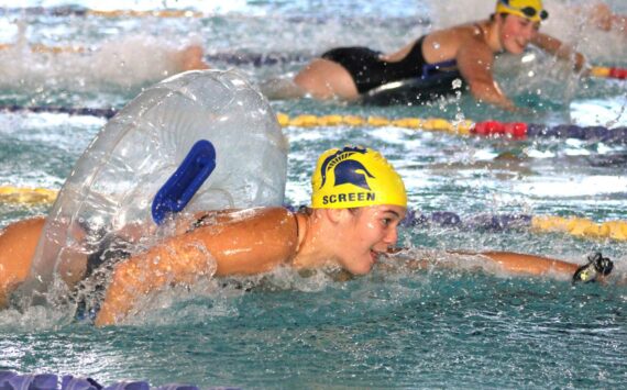 Elisha Meyer/Kitsap News Group photos
Bainbridge sophomore Ruth Screen swims excitedly down her lane toward cheering teammates in a post-meet tube relay race with swimmers from Port Angeles.