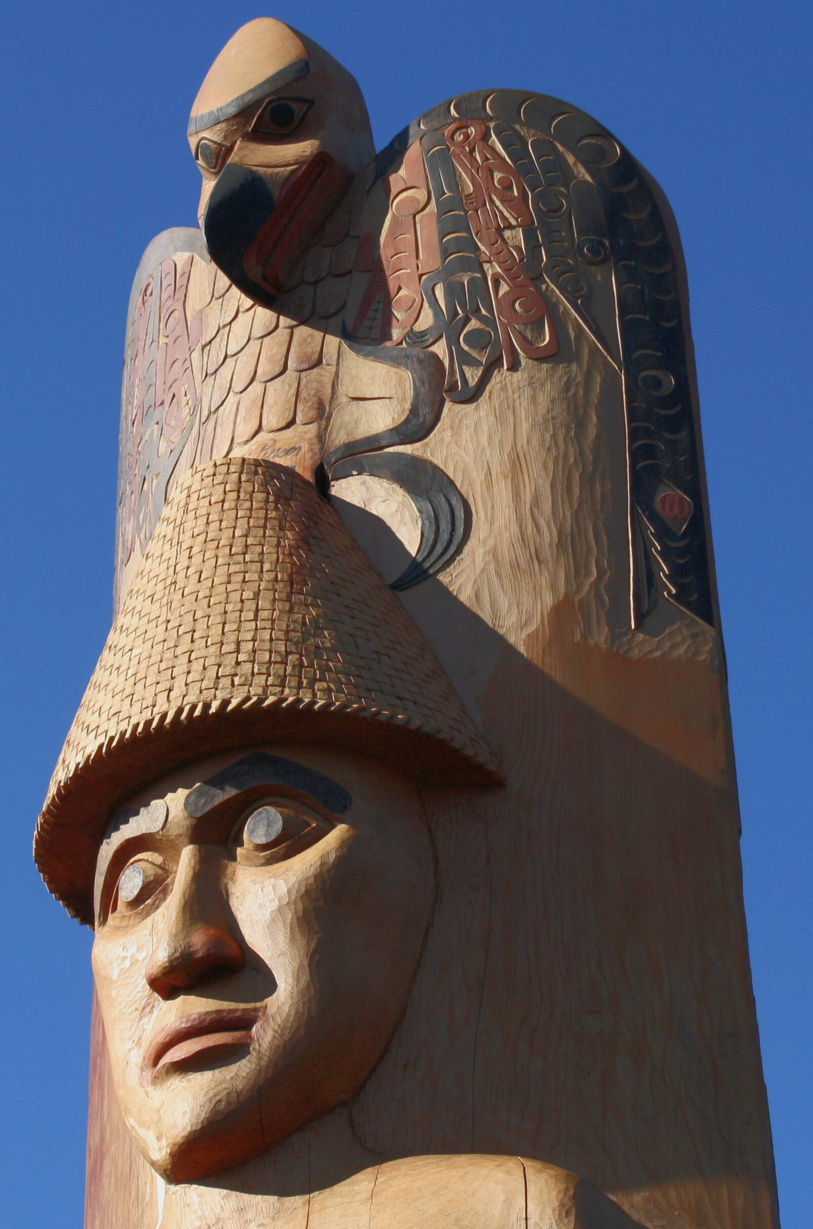 The welcome pole features the only recorded carving of the traditional woven cedar hat that many tribes throughout the Salish Sea wear.