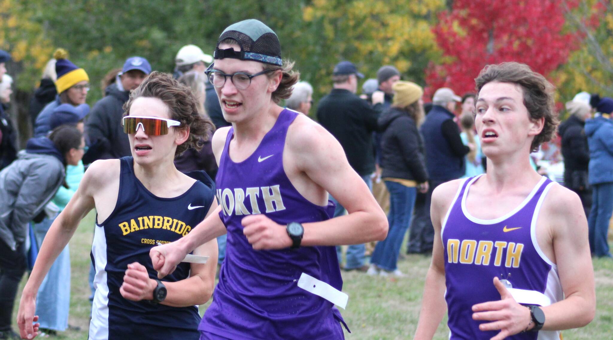 Michael Sanders of Bainbridge and Alex Braun and Sam Corry of NK sprint to the finish line at Battle Point Park.