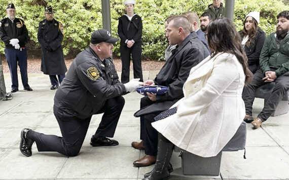 Bergeron family courtesy photos
Bill Bergeron Jr. receives a U.S. flag at a military funeral for his father.