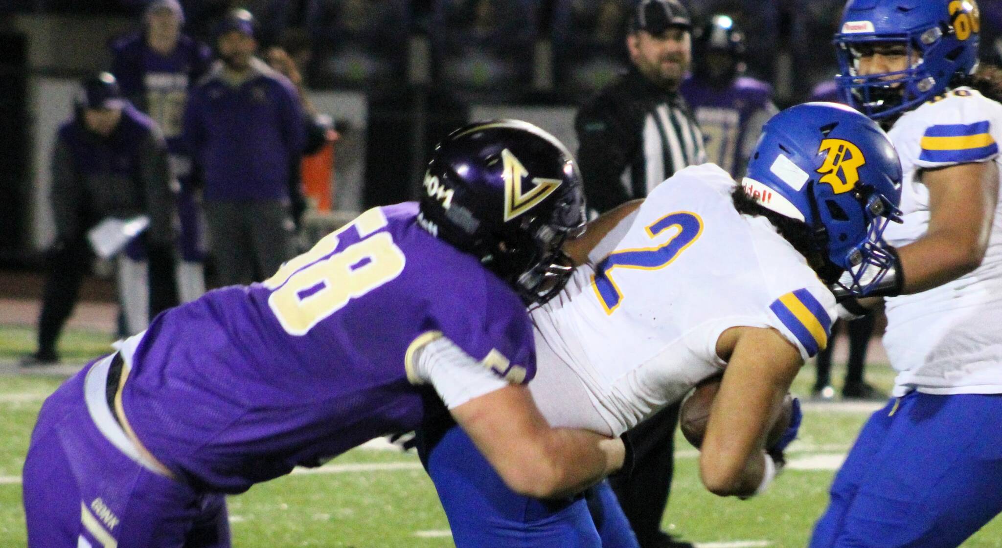 Senior defensive lineman Nate Thornton tackles Bremerton running back Taison Penitusi in the backfield.