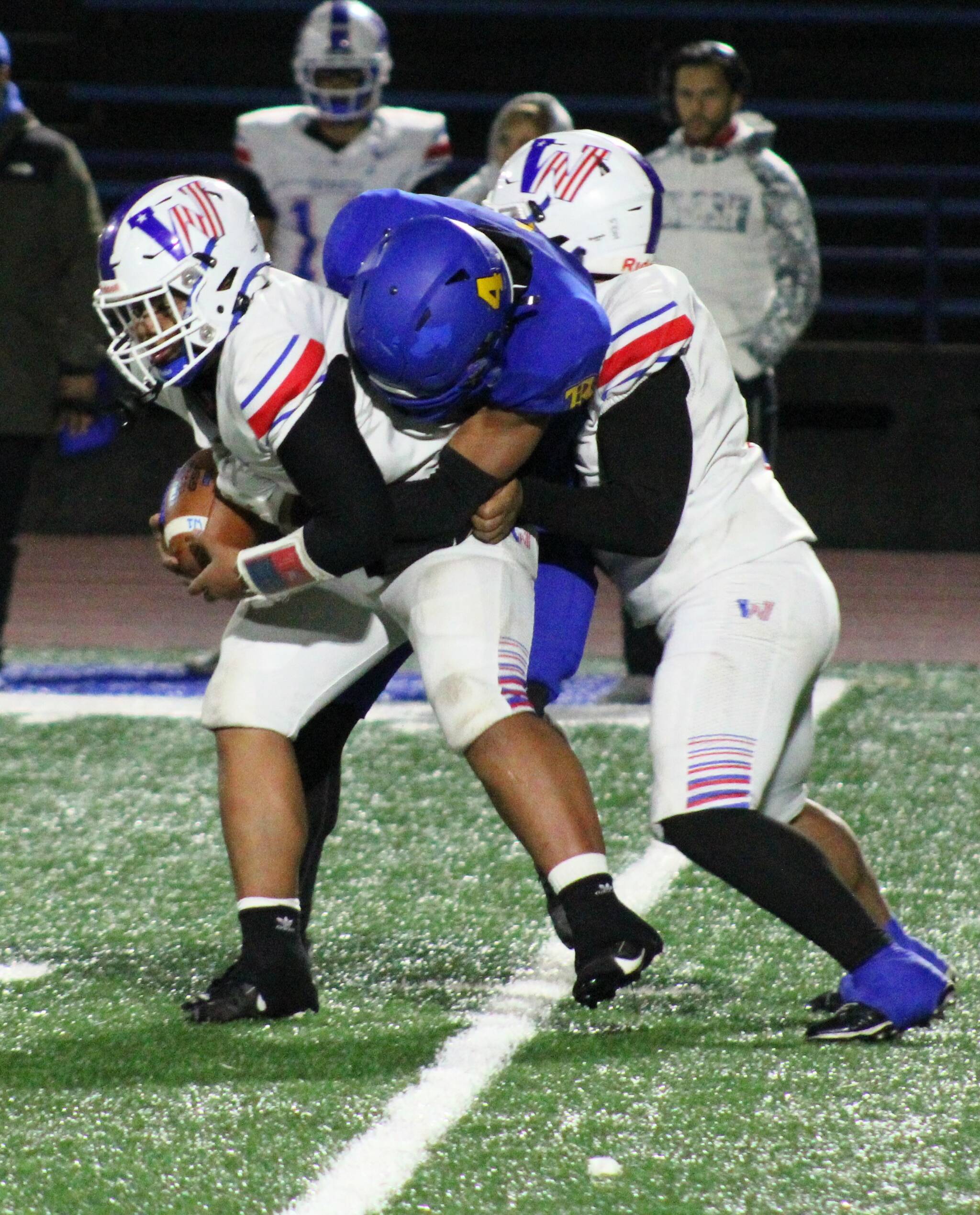 Knight Marquise Allen wraps up the Washington quarterback for a sack at the end of the first half.