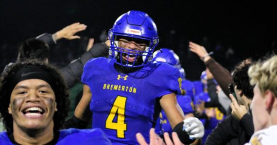 Elisha Meyer/Kitsap News Group
Junior Marquise Allen (No. 4) sprints into a crowd of teammates and Bremerton students to celebrate the Knights’ walk-off touchdown Nov. 5