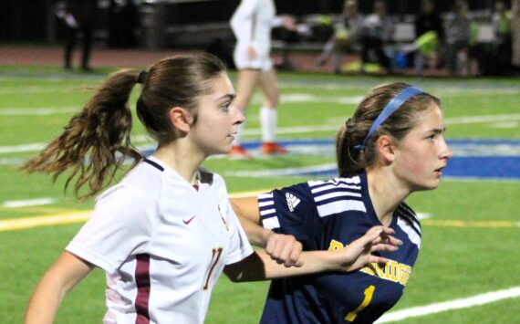 Elisha Meyer/Kitsap News Group photos
Kingston sophomore Emily Kispert and Bainbridge freshman Vega Hendrickson battle for better ground while watching the ball.