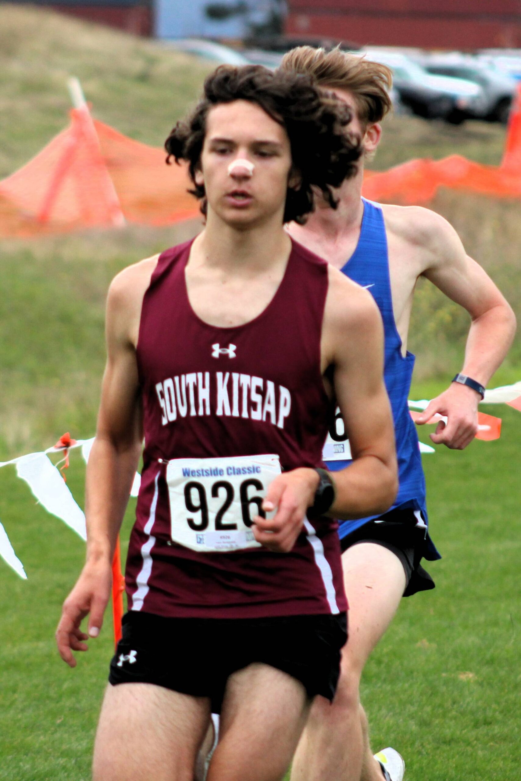 South Kitsap junior Isaac Benjamin tries to keep an approaching runner behind him at districts Nov. 2.