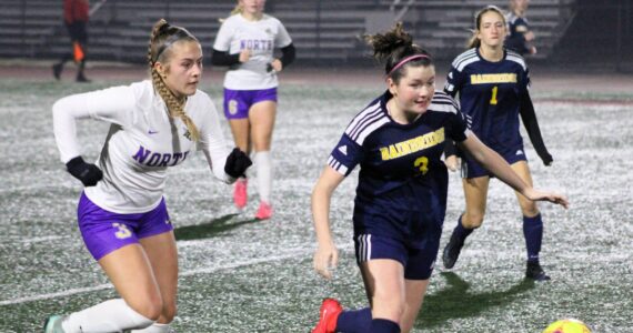 Elisha Meyer/Kitsap News Group
North Kitsap senior Andrea Zetty and Bainbridge junior Izzi Pujolar chase down the ball in the second half of the district championship match.