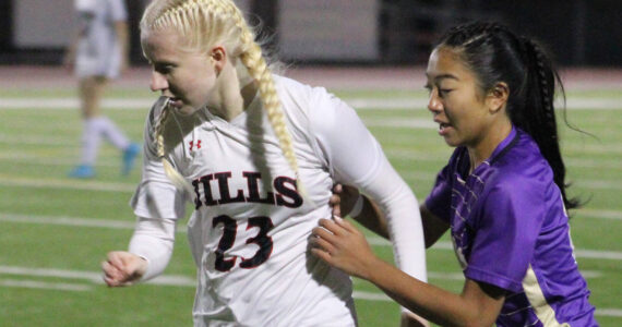 Elisha Meyer/Kitsap News Group
North Kitsap junior Addy Jueco tries to get the ball from a Lumberjills player in the first half of the Vikings’ state opener.