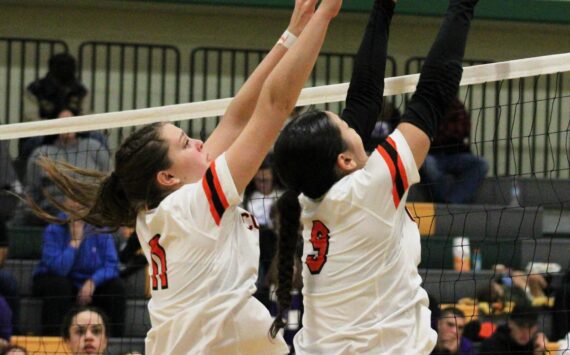 Elisha Meyer/Kitsap News Group
Central Kitsap’s Macy Holyoak, left, and Elliana Smith go up for a block against North Thurston in their district title match Nov. 16.