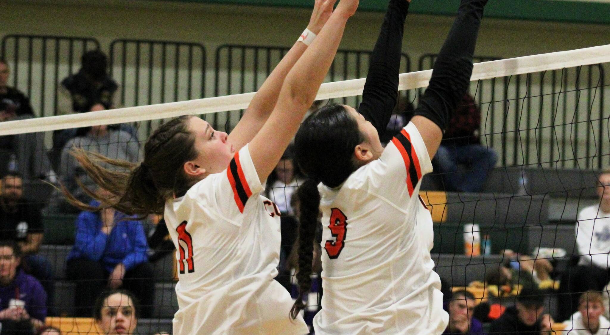 Elisha Meyer/Kitsap News Group
Central Kitsap’s Macy Holyoak, left, and Elliana Smith go up for a block against North Thurston in their district title match Nov. 16.