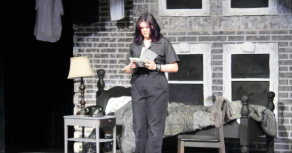 Molly Hetherwick/Kitsap News Group photos
Working-class ‘greaser’ Ponyboy (Lily Terp) reads an inscription in a friend’s book.