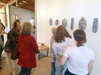 Coney courtesy photo
Isobel Coney, left, speaks to some gallery visitors about her art, displayed on the wall at Grace Episcopal Church.