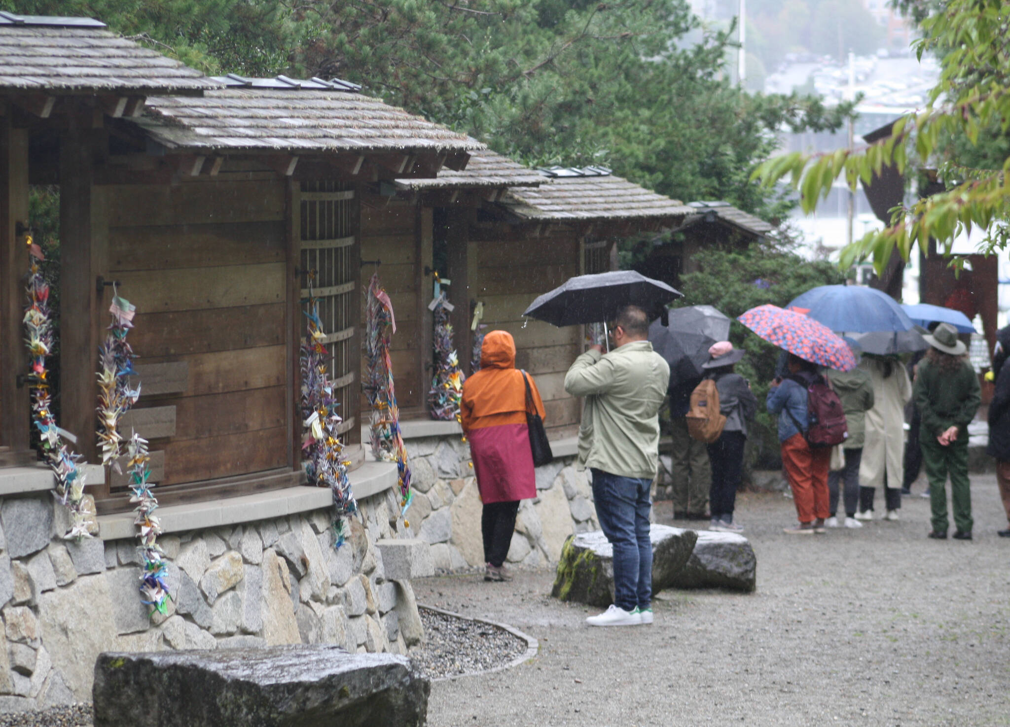 Molly Hetherwick/Kitsap News Group
Visitors check out the memorial on a rainy day. A proposal would put a permanent employee on the site to guide visitors.