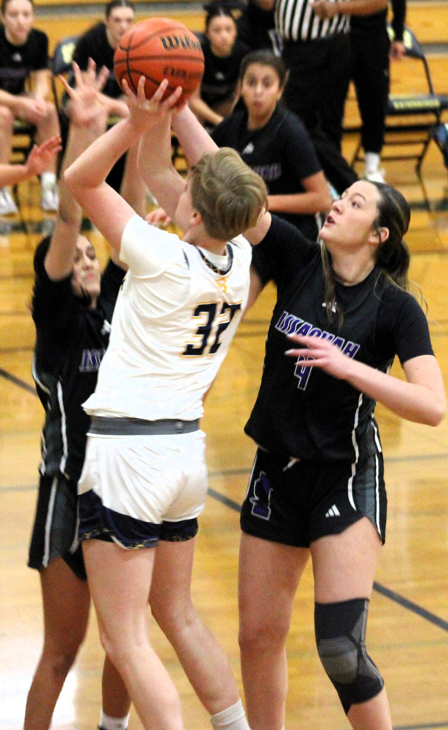 Bainbridge sophomore Anna Rowe goes up against two Issaquah defenders for a short jump shot from the blocks.