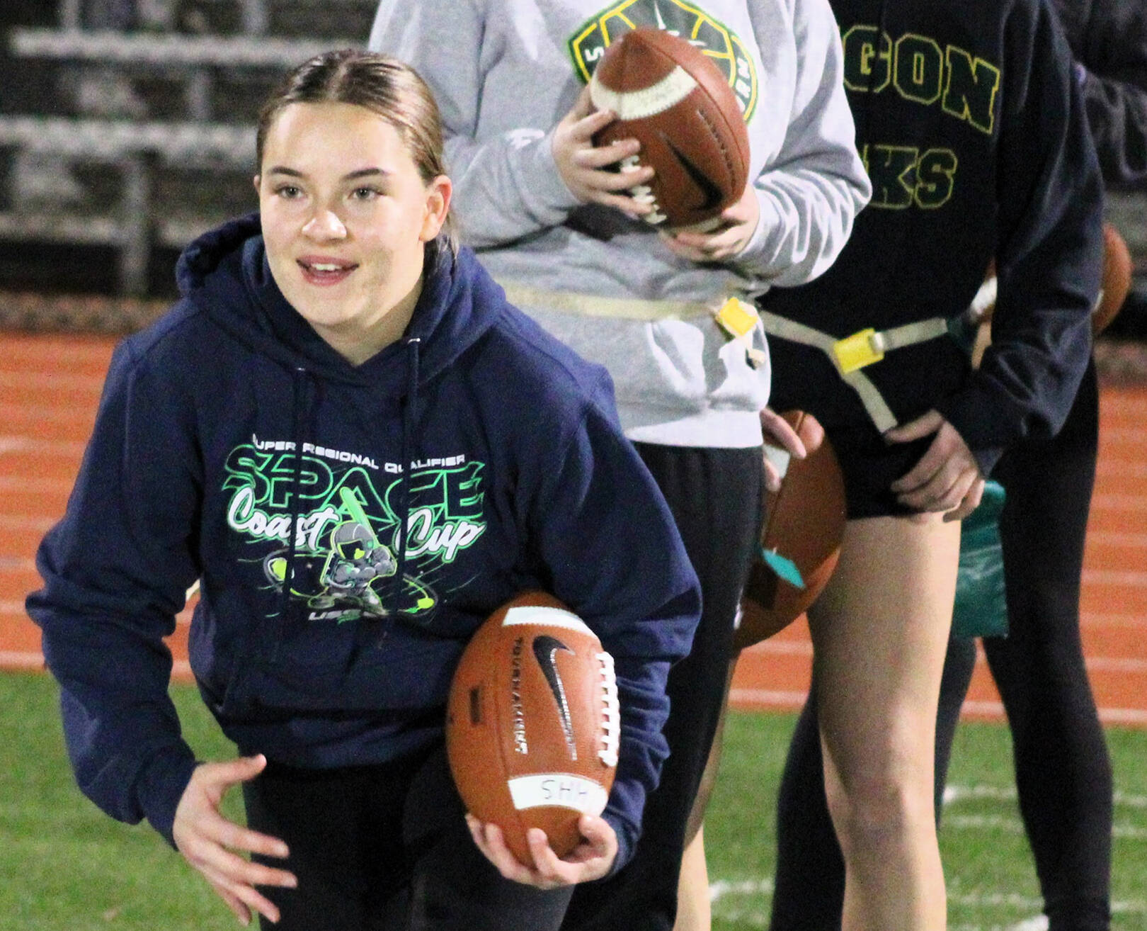 Kingston student Lily Reinbold tries to avoid a defender during an early practice flag pulling drill.