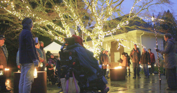 Molly Hetherwick/Kitsap News Group photos
Stroll & Roll attendees listen to a brief orientation and a poem reading celebrating the solstice at the Jan. 3 event.