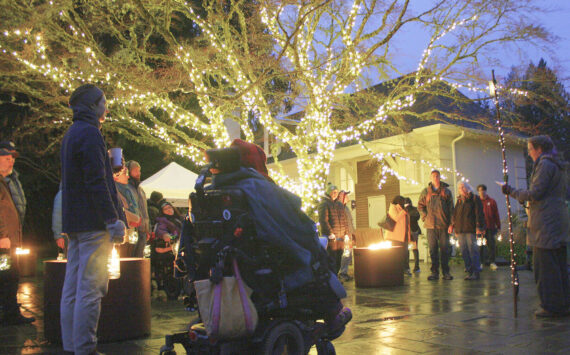 Molly Hetherwick/Kitsap News Group photos
Stroll & Roll attendees listen to a brief orientation and a poem reading celebrating the solstice at the Jan. 3 event.